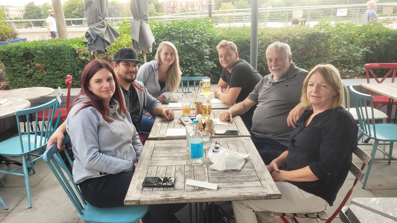 Family sitting together around an outdoor restaurant table