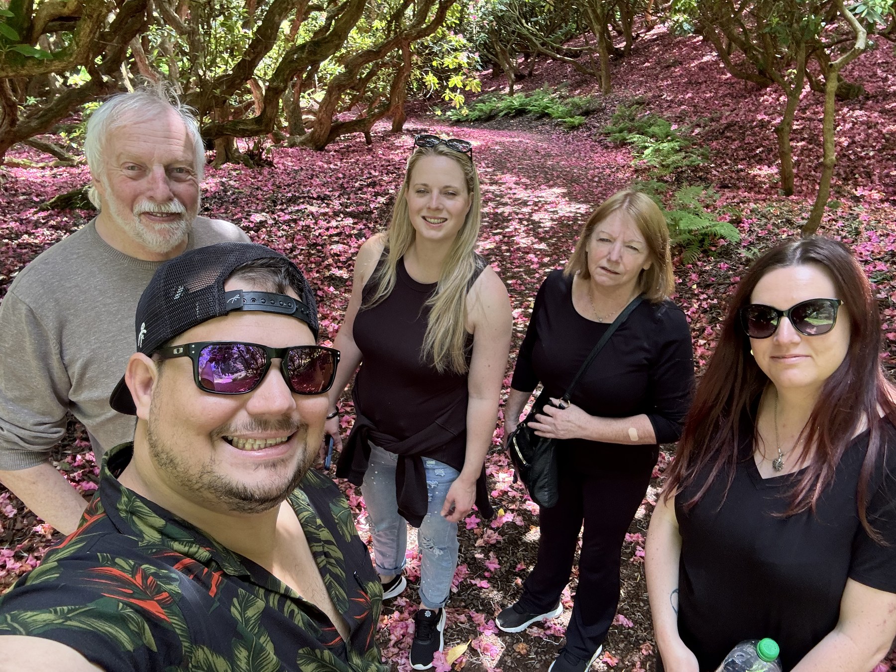 Family group smiling together in a garden