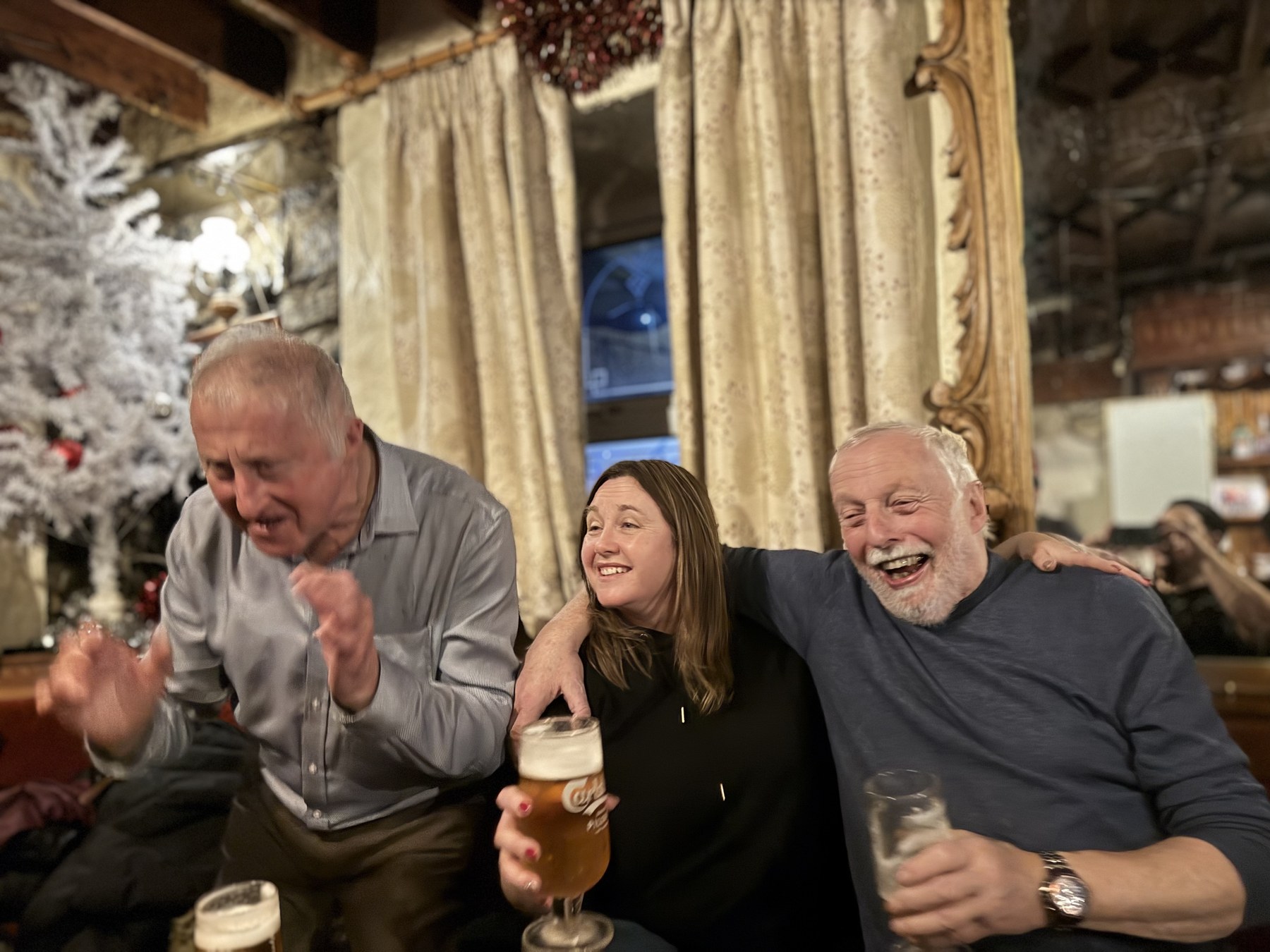 Family laughing together at a pub table