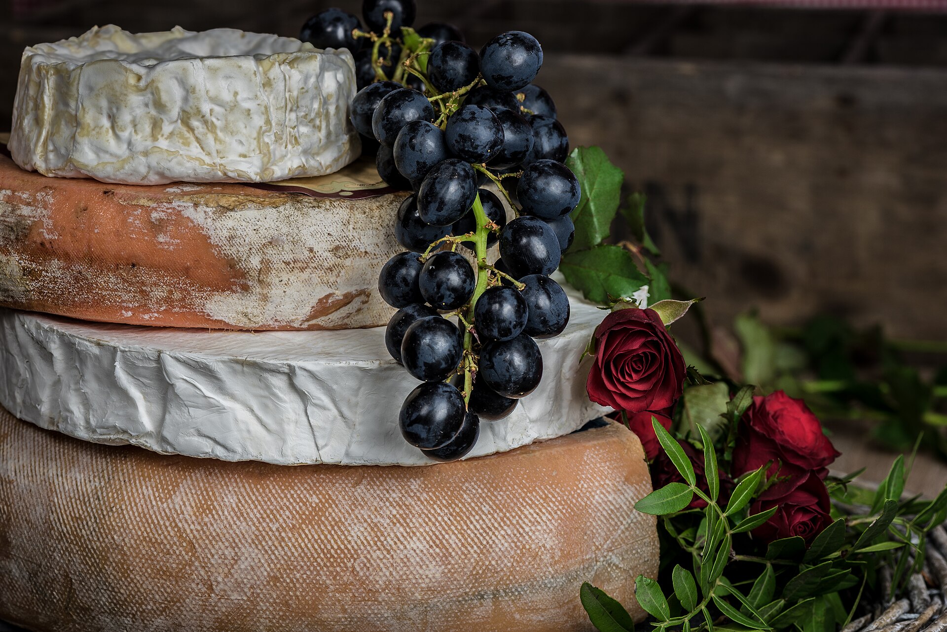 A cheese board with grapes and assorted soft cheeses